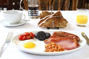 a plate of breakfast food on a table at The Grange Court B&B Hotel in Rockbeare