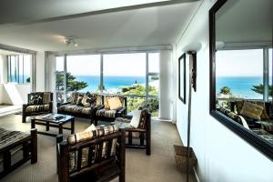 a living room with a view of the ocean at Penguinden - load-shedding free in Simonʼs Town