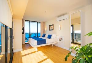 a bedroom with a bed and a view of the ocean at Orbi City Hotel Official in Batumi