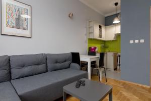 a living room with a couch and a table at Grójecka Stara Ochota Apartment in Warsaw