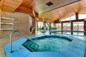 a hot tub in a large room with wooden ceilings at Holiday Inn Express & Suites Bad Axe by IHG in Bad Axe