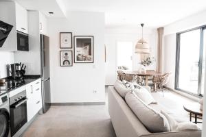 a white living room with a couch and a table at Balcon Del Mar Nerja in Nerja
