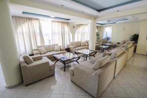 a large living room with couches and tables at Hotel Villa Basil in Tsilivi