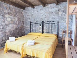 1 dormitorio con 1 cama grande con sábanas amarillas en Casa Tomaso - Turismo Rural, en Reperos