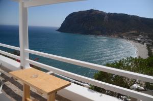 a balcony with a view of a beach and the ocean at Agia Kyriaki Studios in Agia Kiriaki Beach