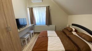 TV a/nebo společenská místnost v ubytování Korall Apartman