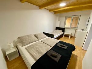 a bedroom with a large bed and a living room at Ubytování GM in Znojmo