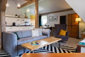 a living room with a couch and a table at Dom Numer 127 in Czarna Góra