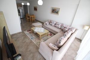 a living room with a couch and a table at Skyview Apartments in Sarandë