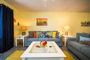 a living room with a couch and a table at Beach Potato - 3404 Gulf Dr 5 in Holmes Beach