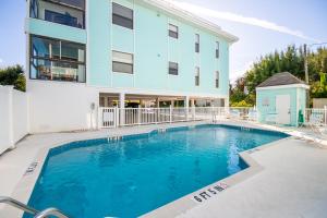 a swimming pool in front of a building at Beach Potato - 3404 Gulf Dr 5 in Holmes Beach