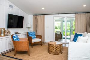 un soggiorno con un divano e una TV di Island Time: AMI North End, Pool, Close to City Pier & Pine Ave by Anna Maria Life Vacation Rentals ad Anna Maria