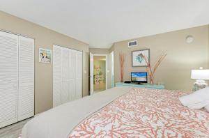 a large bedroom with a bed and a tv at Sunset Beach 102: Gulf Front, Stunning Views, On the Beach, Pool by Anna Maria Life Vacation Rentals in Holmes Beach +31 photos