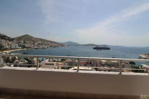 a balcony with a view of the ocean and a city at Skyview Apartments in Sarandë