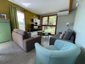 a living room with two couches and a tv at Gîtes Le Bouzet in Salavas +38 photos
