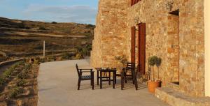 a patio with a table and chairs next to a building at Villa Adeiata in Konizopí