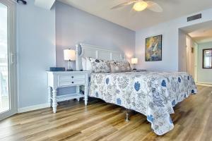 a bedroom with a bed and a dresser and a ceiling fan at Water View 506 in Clearwater Beach +25 photos