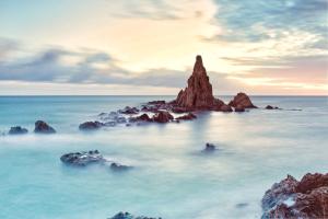 a rock formation in the middle of the ocean at Apartamento Luna Cabo de Gata in El Cabo de Gata