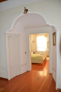 an archway in a room with a bed and a bedroom at Molivos Tower in Mithymna