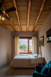 a bedroom with a bed and a window at Villa del Cielo in Tilcara