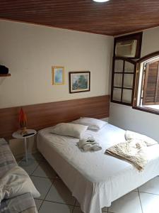 Giường trong phòng chung tại Pousada das Pedras