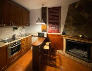 a kitchen with a fireplace and a stove top oven at Calle Nueva 12 in Cazorla