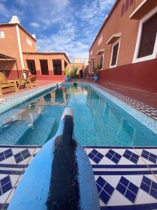 a pool with a dolphin in the middle of a building at Auberge Ksar Ait Ben Haddou in Aït Ben Haddou