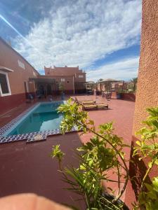 a courtyard with a swimming pool and a building at Auberge Ksar Ait Ben Haddou in Aït Ben Haddou