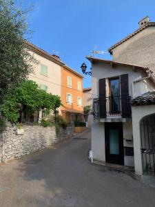 an empty street in a town with buildings at TinyHouse in La Roquette-sur-Siagne