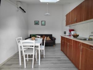 a kitchen with a table and chairs and a couch at Apartments Urban Porec in Poreč