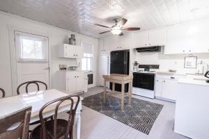 a kitchen with white cabinets and a table in it at Schilling House in Harpers Ferry