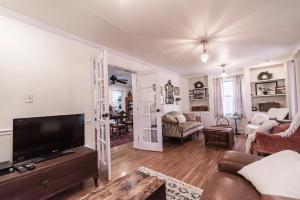 a living room with a couch and a tv at Riley House in Harpers Ferry