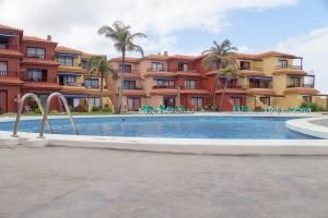 a swimming pool in front of some apartments at Casa Ramón Acosta in Breña Baja