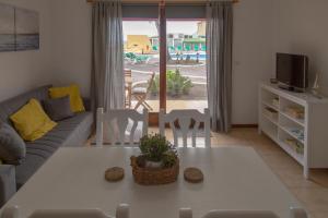 een woonkamer met een bank, een tafel en stoelen bij Casa Ramón Acosta in Breña Baja