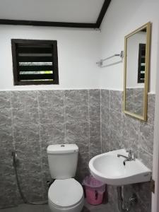 a bathroom with a toilet and a sink at Bundal Riverside Room#1 in Itaytay