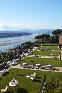 a park with picnic tables and a view of the water at Parador de Ribadeo in Ribadeo