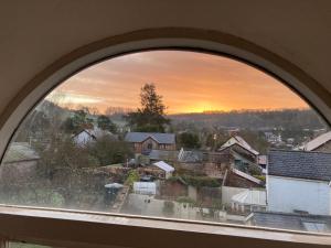 an arched window with a view of a city at Six on Castle in Tiverton