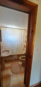a bathroom with a toilet and a sink at Tonia’s & Chris House in Kalliópi +15 photos