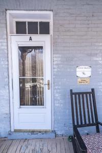 a door on a house with a sign on it at Armory Quarters A in Harpers Ferry