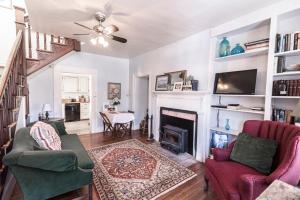 a living room with two chairs and a fireplace at Armory Quarters A in Harpers Ferry