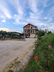 a large house on the side of a dirt road at SLATKI SNOVI II in Knin