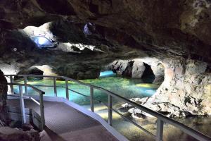 una escalera en una cueva con una piscina de agua en Berghotel Kristall, en Idar-Oberstein