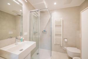 a bathroom with a shower and a sink and a toilet at stella alpina in Dobbiaco +10 photos