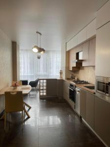 a kitchen with a table and a dining room at Resident Hall in Lviv
