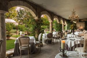 a dining room with tables and chairs in a restaurant at Borgo Santo Pietro in Chiusdino