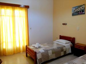 a bedroom with a bed and a large window at Villa Fondas Roda in Roda