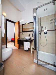 a bathroom with a shower and a sink at Hotel Cala Luna in Cala Gonone