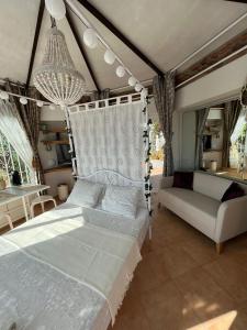 a bedroom with a white bed and a couch at Casa Hermosa in Torre de Benagalbón