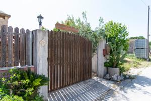 a wooden fence with a gate in a yard at Baglio Mustazza in Buseto Palizzolo