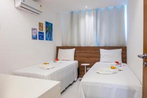 a room with two beds with white sheets and a window at Solar Porto Rico in Porto De Galinhas +34 photos